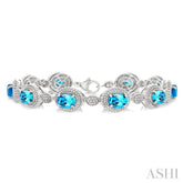 7X5 MM Oval Shape Blue Topaz and 1/10 Ctw Round Cut Diamond Semi-Precious Bracelet in Sterling Silver