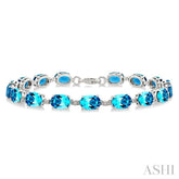 7X5 MM Oval Shape Blue Topaz and 1/10 Ctw Round Cut Diamond Semi-Precious Bracelet in Sterling Silver